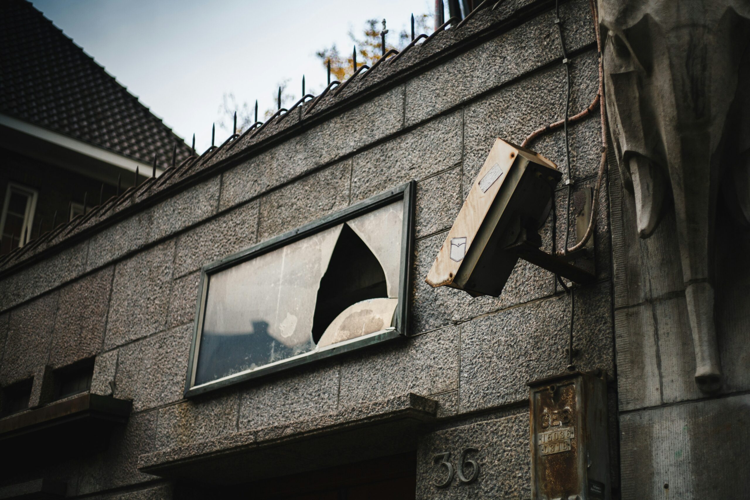 an apartment with broken glass windows