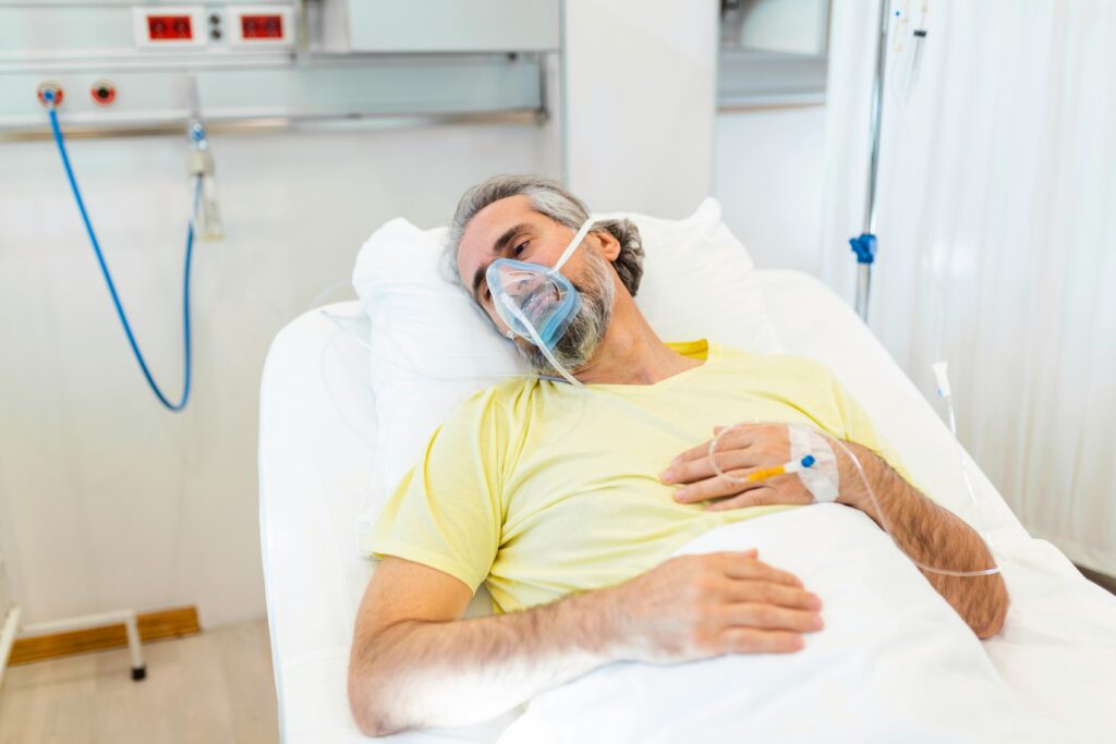 a person hospitalized and wearing a mask because of respiratory issues