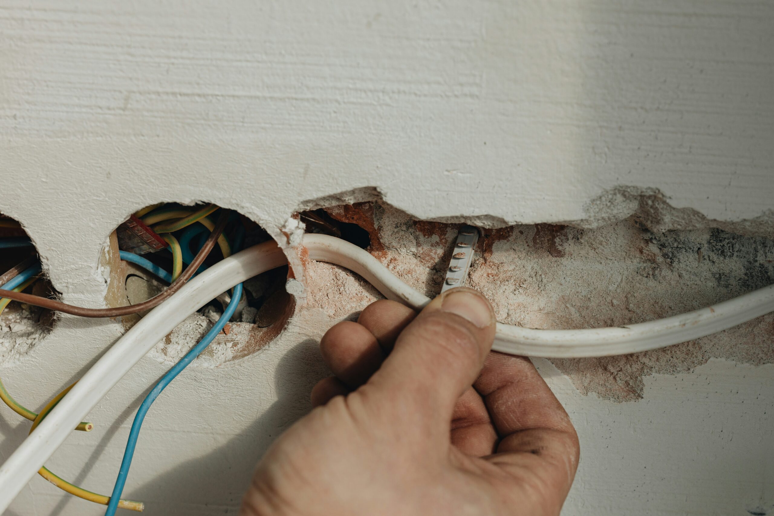 person inspecting an apartment's electrical wiring